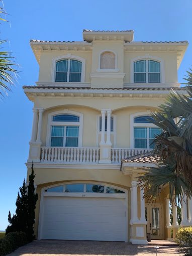 Mediterranean-style beach house with detailed exterior columns and trim