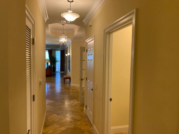 Painted interior hallway with detailed white crown molding and trim